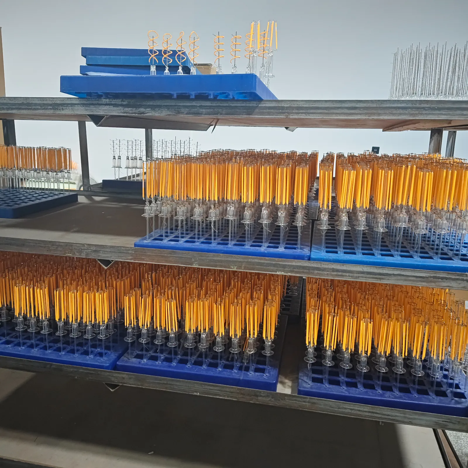 Prepared LED filament components arranged in trays at the GLORILUM workshop